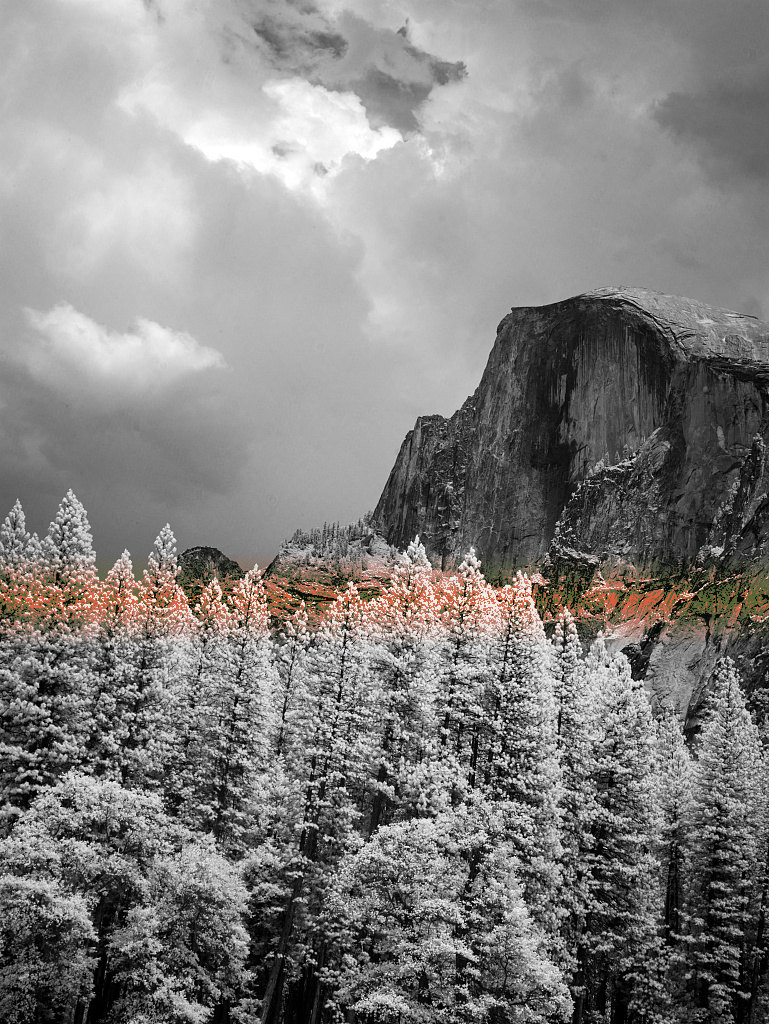 The same photograph with one vermilion dithered band across the upper sky; the mountain and forest are unchanged.
